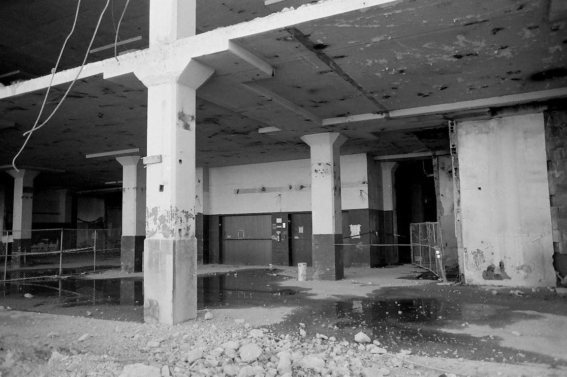 A black-and-white photo of an abandoned building.